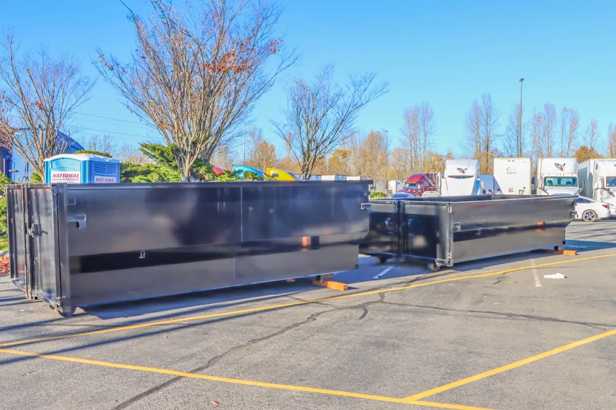 Professional dumpster rental service with roll-off container on residential driveway in Cumming